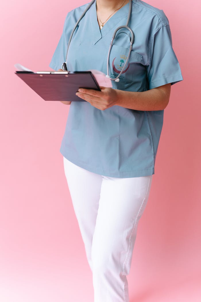 A Close-Up Shot of a Doctor Holding a Clipboard